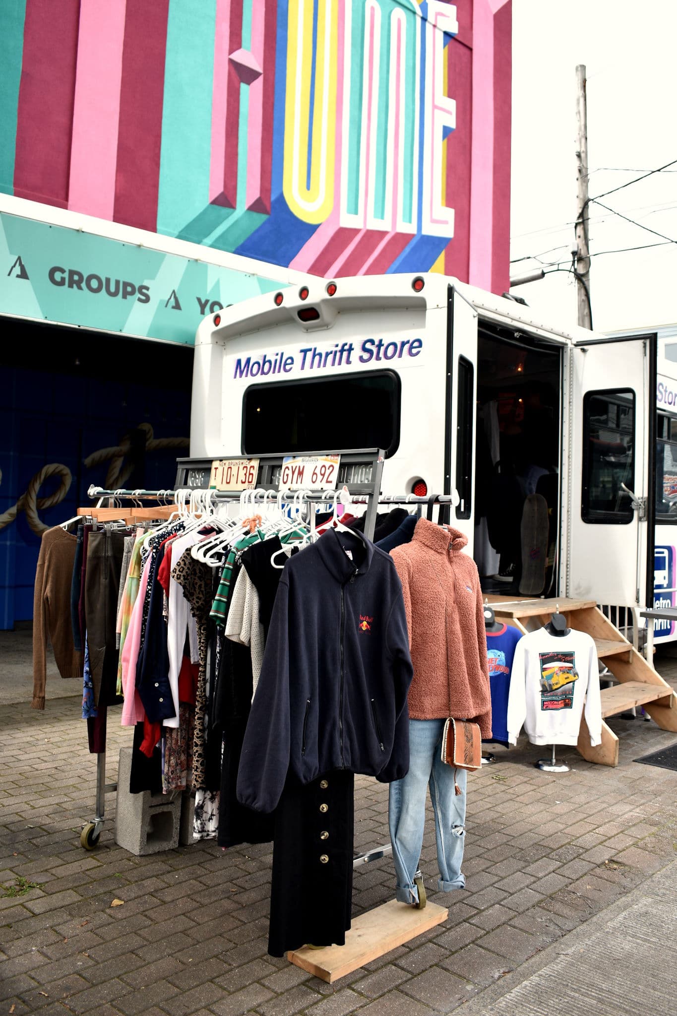 Clothing racks set up outside the Thrift Bus